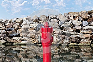 Hydrant concept against a wall of rocks - Plenty of water concept