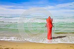 A hydrant at the seaside. Plenty of water: concept image