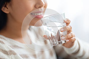 Hydration Concept. Closeup Shot Of Smiling Young Lady Drinking Water From Glass