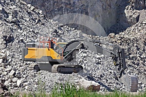 Hydraulic crawler excavator in stone quarry at work