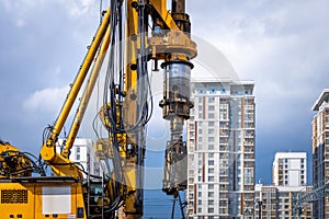 Hydraulic drilling rig for construction of a cast-in-situ piles with a casing string on a construction site. Concrete