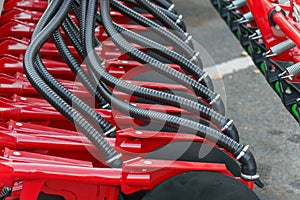 Hydraulic drive connecting agricultural machinery units. Pneumatic hoses and electrical cables at an industrial facility.