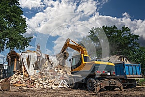 Hydraulic Excavator Breaks House. Building Demolition or Destruction for New Construction