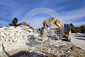 Hydraulic excavator-destroyer on a building demolition site