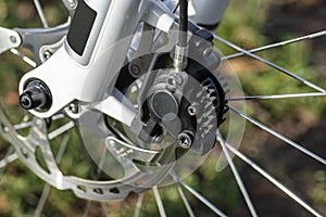 Hydraulic front disc brake on mountain bike with bicycle hub, caliper and spokes.