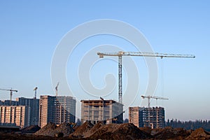 Hydraulic luffing jib tower cranes and workers being poured concrete into foundation