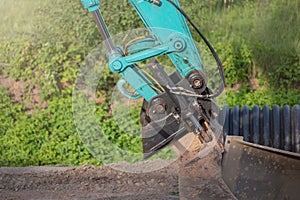 Hydraulic part of a large excavator close-up. The subject of repair and maintenance of heavy construction large-sized