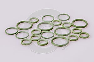 Hydraulic and pneumatic o-ring seals of different sizes scattered a white background.