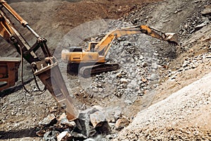 Hydraulic track type excavator backhoe machinery working. Industrial machineries working on open pit mine, ore quarry