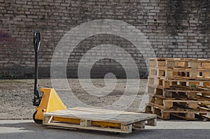 hydraulic trolley with wooden pallet for loading. Pallet jack