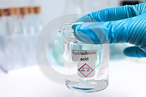 Hydrochloric acid in glass, chemical in the laboratory photo