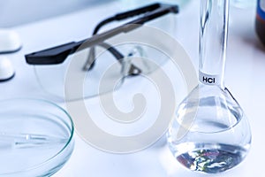 hydrochloric acid in glass, chemical in the laboratory and industry photo
