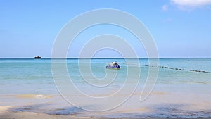 A hydrocycle near the shore sways in the waves on a clear sunny day. Water bike in the sea.