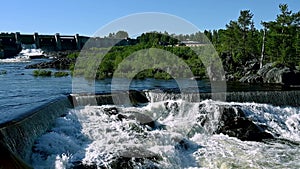 Hydroelectric dam with flowing water. Fairy waterfall at wild forest. Wonderful fresh water