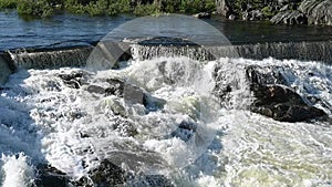 Hydroelectric dam with flowing water. Fairy waterfall at wild forest. Wonderful fresh water