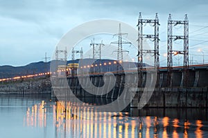 Hydroelectric power station on river at evening photo
