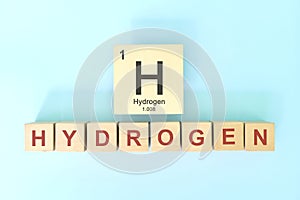 Hydrogen chemical element symbol with atomic mass and atomic number in wooden blocks flat lay composition.