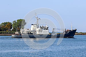 Hydrographic vessel sails along the seashore