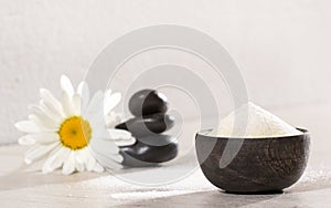 Hydrolyzed collagen protein in wooden bowl and flower photo