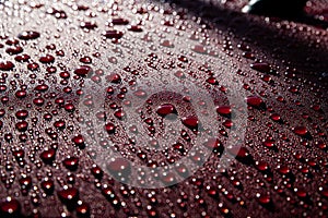 Hydrophobic water effect on red car paint after rain. photo