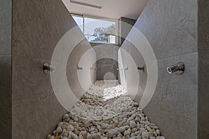 Hydrotherapy massage corridor with water jets and natural stones. Wellness SPA center with healthy procedures.