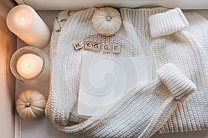 Hygge flatlay with sweater and candles