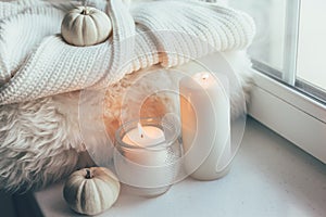 Hygge scene with sweater and candles photo