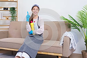 Hygiene cleaning concept, Housemaid doing thumbs up and holding cleaning solution to cleaning house