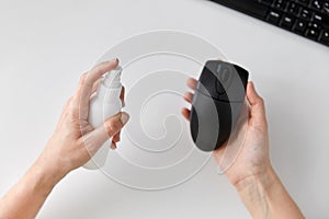 Close up of woman cleaning computer mouse photo