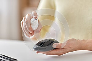 Close up of woman cleaning computer mouse photo