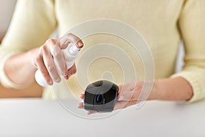 Close up of woman cleaning computer mouse photo