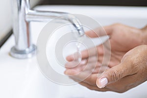 Hygiene. Cleaning Hands. Washing hands with soap under the faucet with water