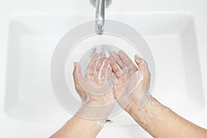 Hygiene. Cleaning Hands. Washing hands with soap under the faucet with water Pay dirt