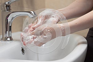Hygiene. Cleaning Hands. Washing hands with soap. Woman`s hand with foam. Protect yourself from coronavirus COVID-19 pandemia.