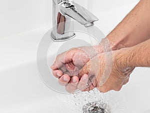 Hygiene concept hand detail, close up. Man cleaning hands, washing hands with soap bubbles