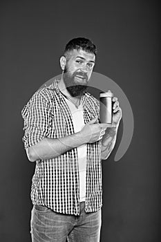 Hygiene habits for men. Hipster holding gel or shampoo bottle for personal hygiene on grey background. Bearded man with