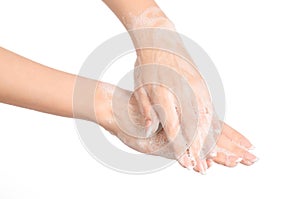 Hygiene and health protection topic: a woman's hand in soapsuds isolated on white background in studio