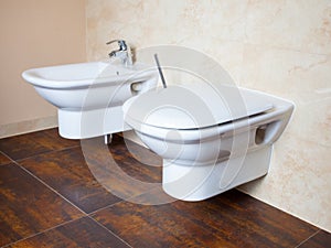 Hygiene. White porcelain bidet and toilet. Interior of bathroom.