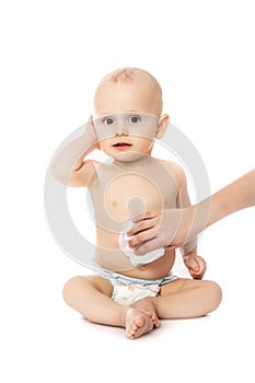 Hygiene - young momy wiping the baby skin with wet wipes isolated on a white background