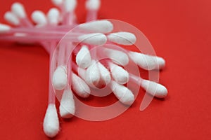 Hygienic cotton buds on a red background