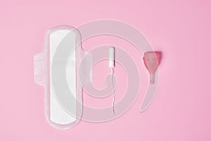 hygienic feminine tampon for menstruation, menstrual cup, pad on pink background