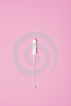 hygienic feminine tampon for menstruation on pink background