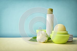 Hygienic lipstick and balm on table