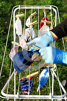 Hygienic mask hanging on the rack outdoor after being washed for cleanness and hygiene during Covid-19 virus outbreak. Drying mask