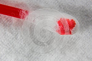 Hygienic stick in the blood is on a cotton pad macro