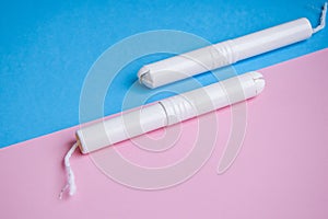 Hygienic tampons on a blue and pink background. copy space, Menstruation sanitary tampon for woman hygiene protection. Critical