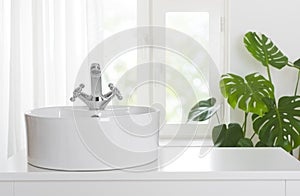 Hygienic wash basin with chrome faucet on bathroom window background photo