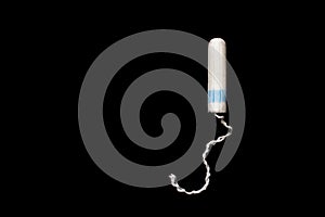 Hygienic white tampon for women. Cotton swab. Menstruation, means of protection. Tampons on a black background.