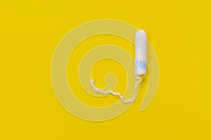 Hygienic white tampon for women. Cotton swab. Menstruation, means of protection. Tampons on a yellow background.