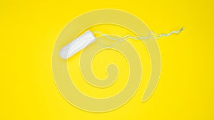 Hygienic white tampon for women. Cotton swab. Menstruation, means of protection. Tampons on a yellow background